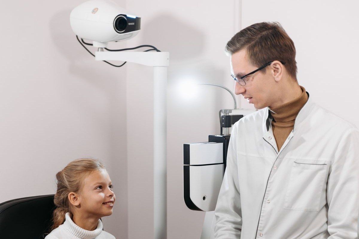 Doctor talking with a smiling young patient during a gentle checkup