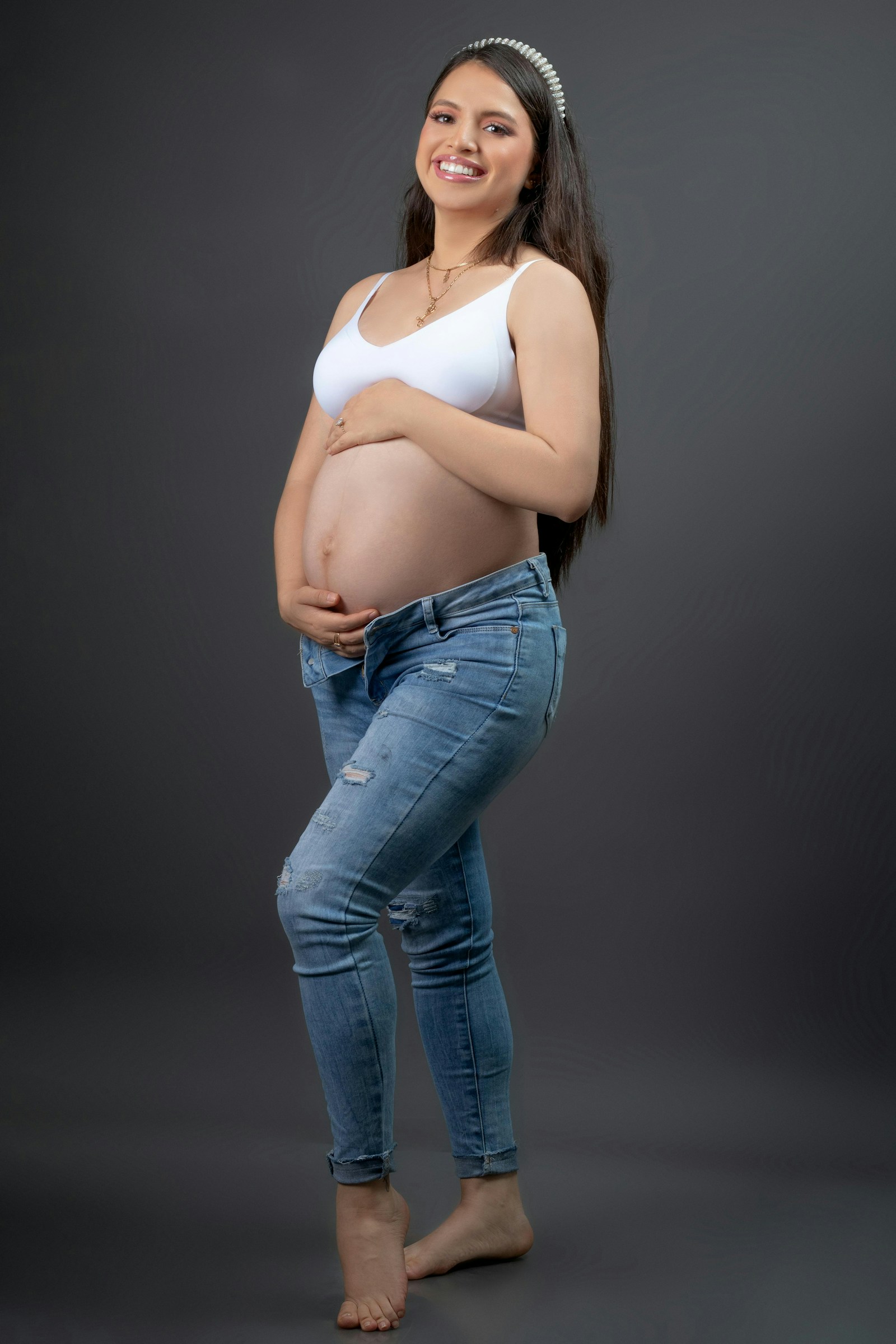 Happy expecting mother smiling and enjoying a comfortable pregnancy