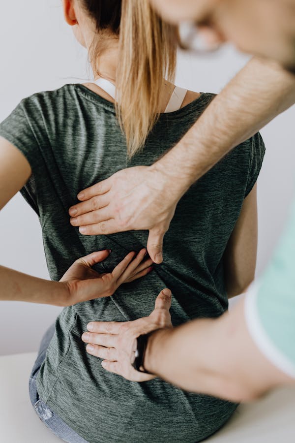 Chiropractor examining an athlete's back